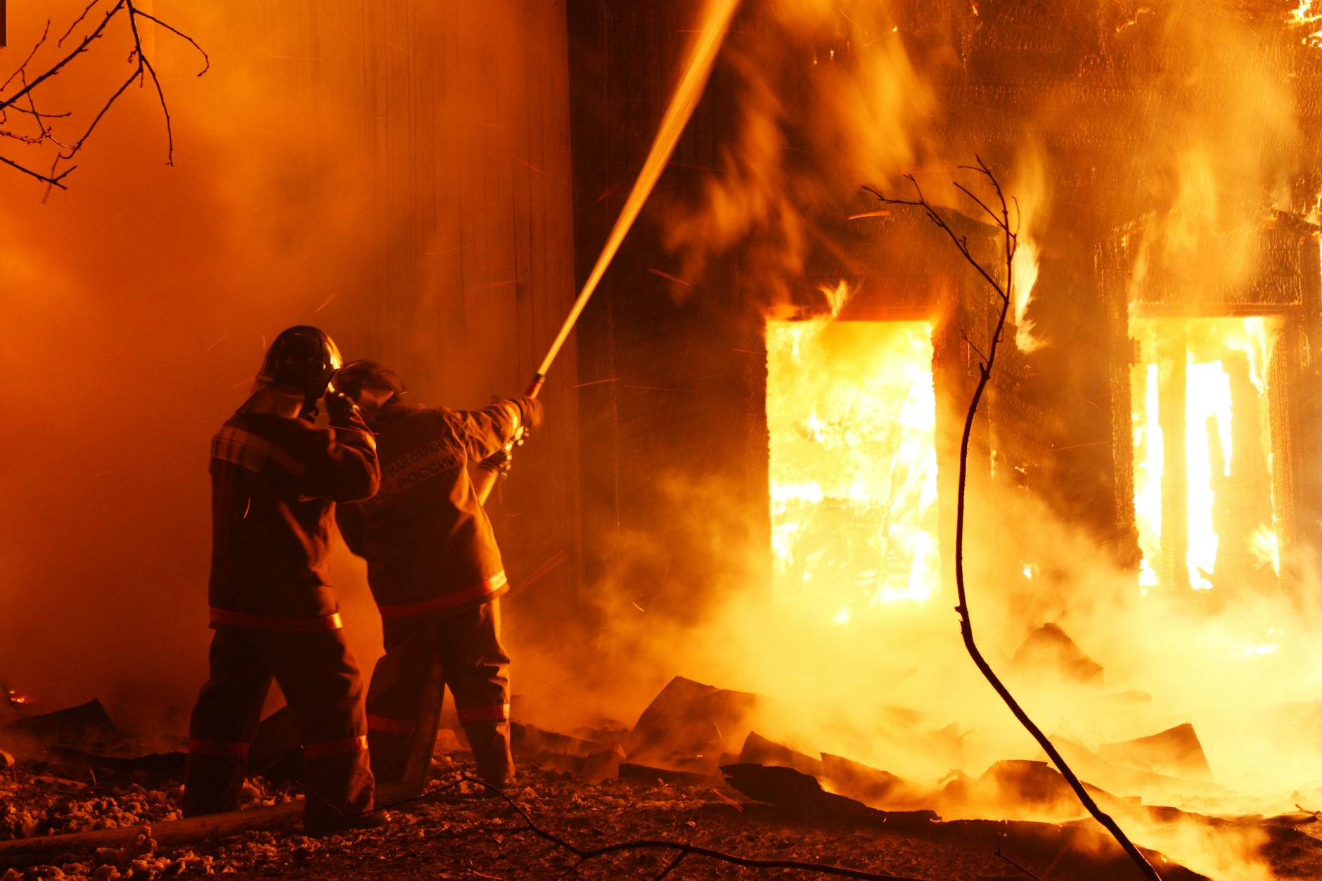 firefighters spraying water in fire photo